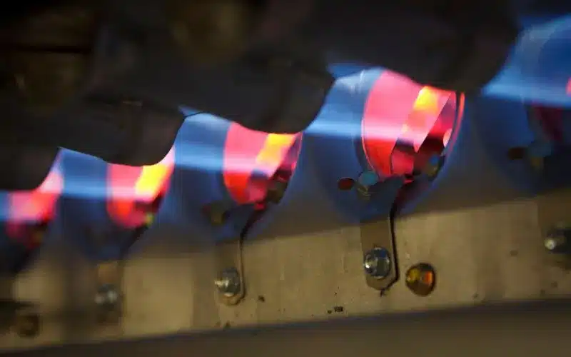 Home Heating Tips: Stay Warm and Save in Winter 2025 2 A close-up of a furnace igniter with blue flames heating red elements